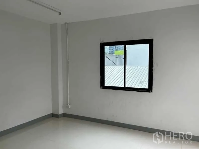 Office Space for rent in Bang Rak, Bangkok - Bright small room with single sliding window and white tile floor.