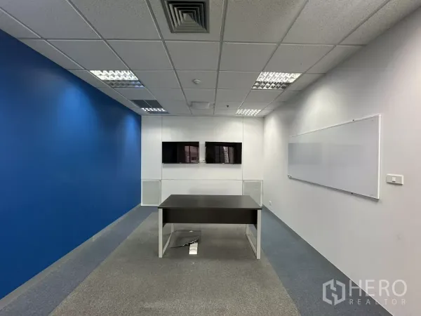 Office Space for rent in Watthana, Bangkok - Small meeting room with two wall-mounted screens and a whiteboard.