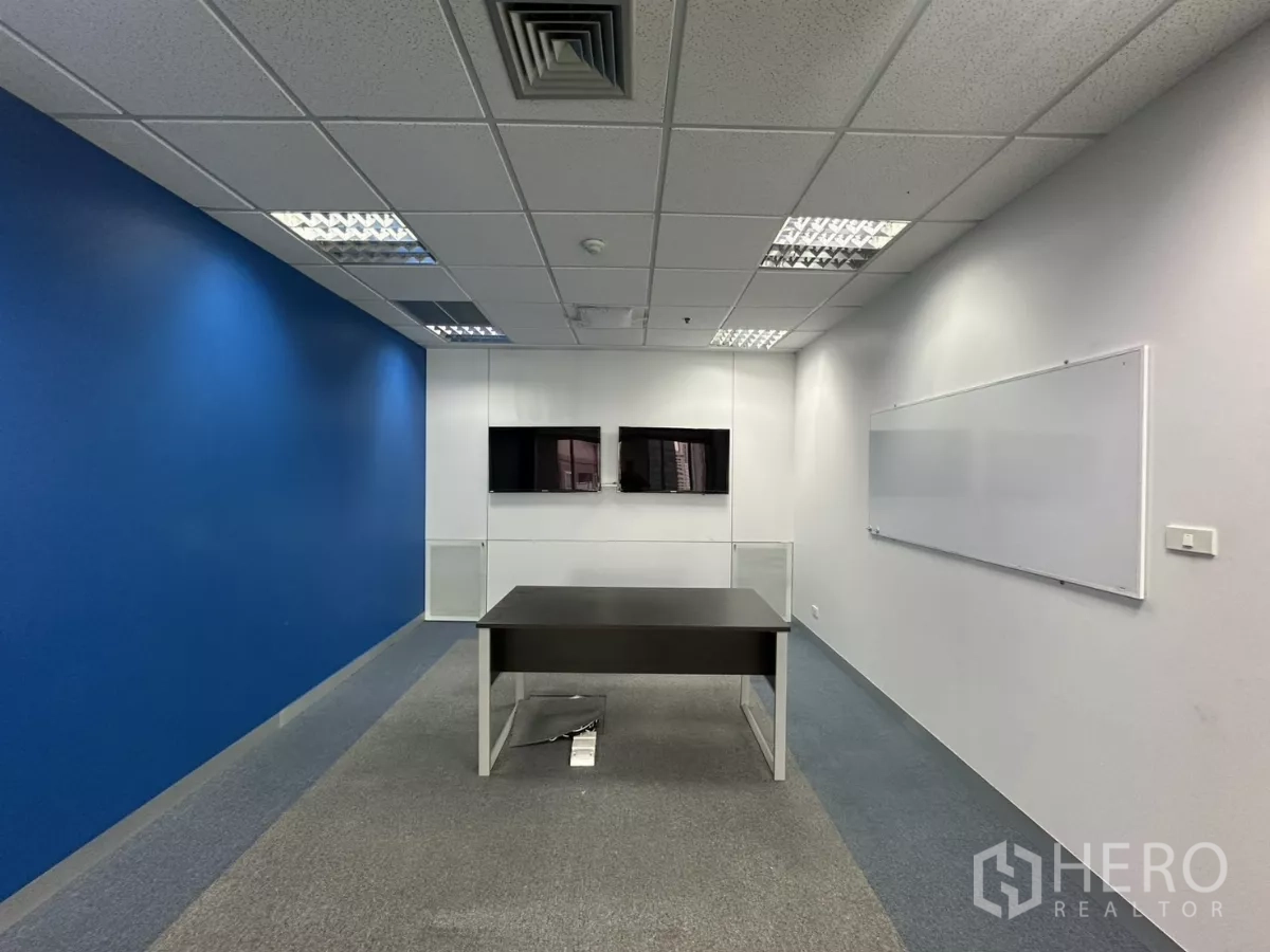 Office Space for rent in Watthana, Bangkok - Small meeting room with two wall-mounted screens and a whiteboard.