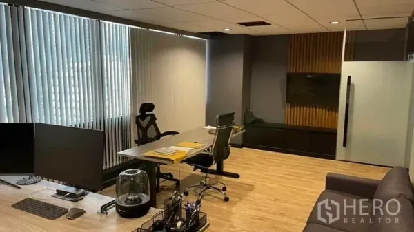 Office Space for rent in Khlong Toei, Bangkok - Executive office with vertical blinds, ergonomic chairs, wall-mounted TV and wood flooring.