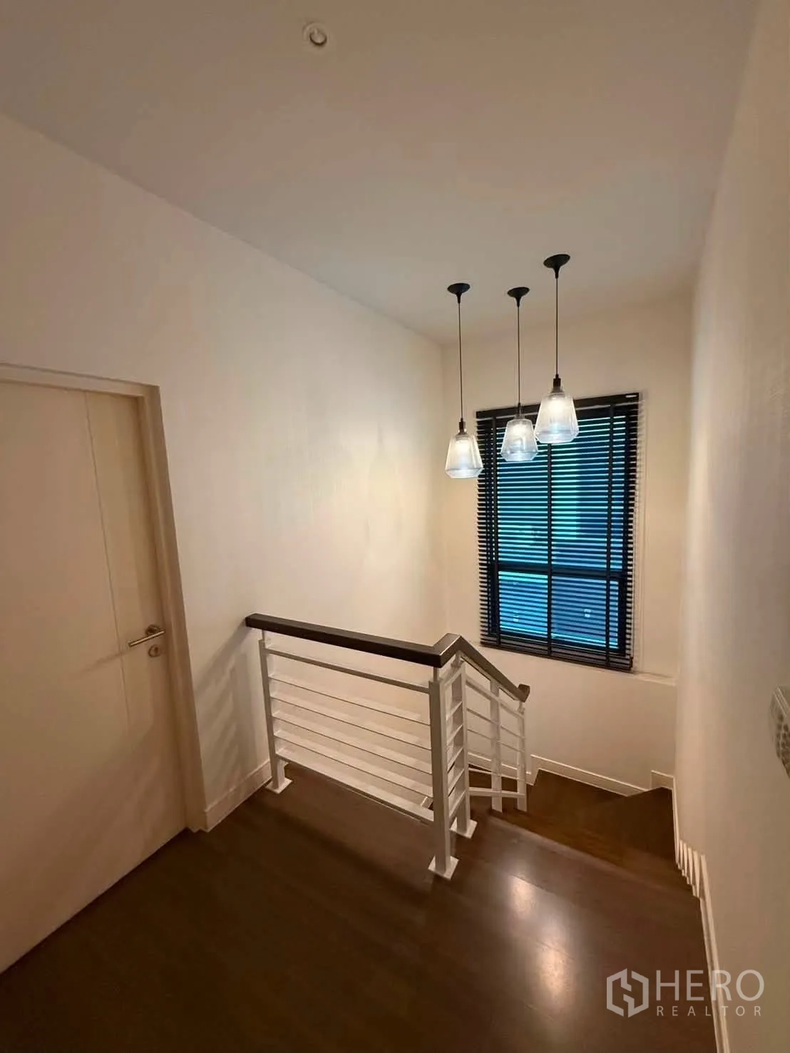 Detached House for rent in Bang Kapi, Bangkok - Stair landing with pendant lights and a window with horizontal blinds.