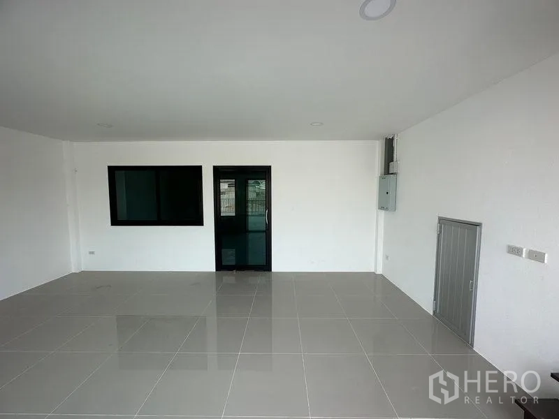 Factory for rent or sale in Bang Bua Thong, Nonthaburi - Ground‑floor office room with window, electrical panel and rear access door.