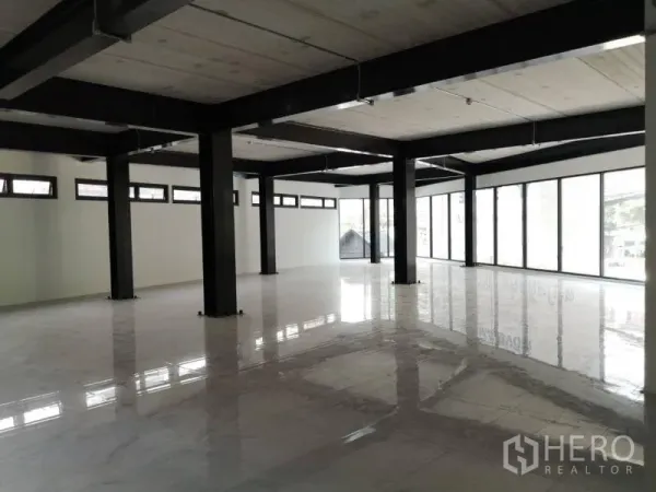 Office Space for rent in Chatuchak, Bangkok - Open‑plan office interior with black steel columns, polished white tile floors and full‑height windows.