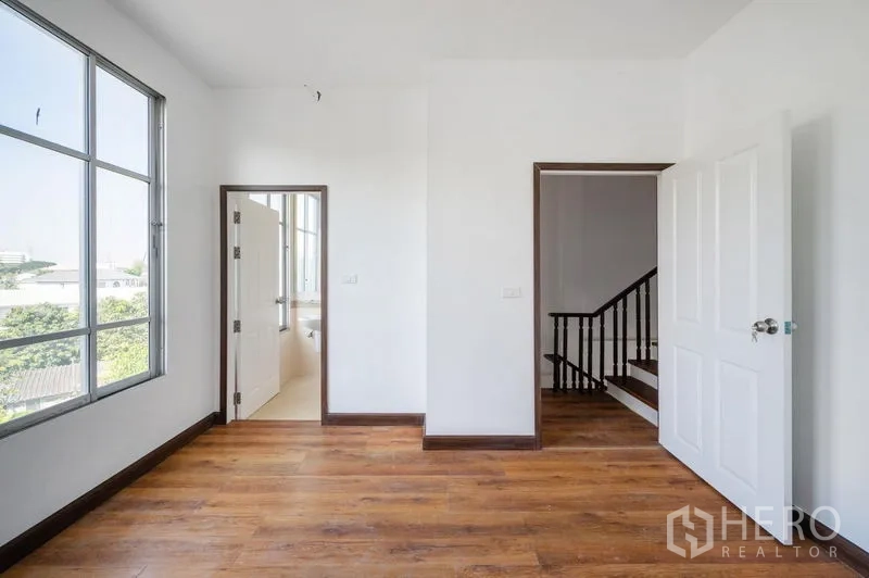 Townhouse for sale - Corner bedroom with big windows and a door to the ensuite bathroom.