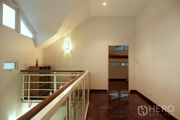 Apartment for rent in Khlong Toei, Bangkok - Upper mezzanine landing with railing and wood floors in duplex
