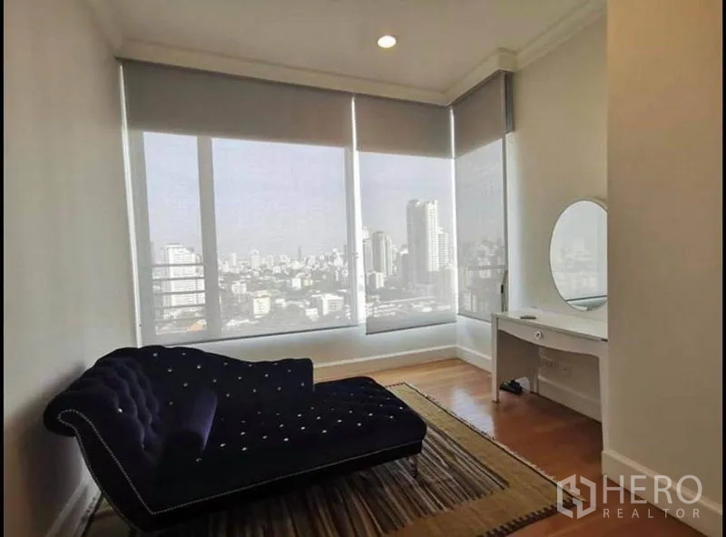 Condominium for rent in Watthana, Bangkok - Bright multipurpose room with chaise lounge, vanity, and wide city views.