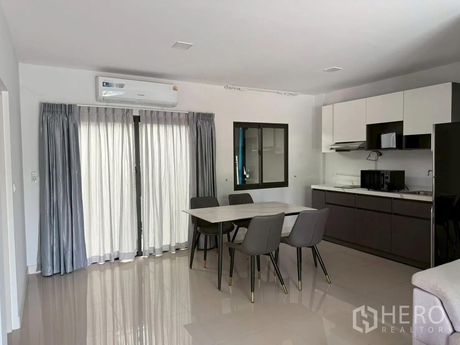 联排别墅 for rent in Bang Phli, Samut Prakan - 开放式厨房与餐区，配餐桌、橱柜、微波炉和冰箱。