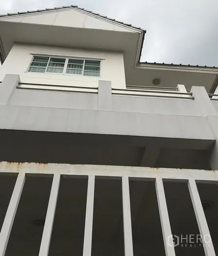 独立式住宅 出租在Din Daeng, Bangkok - 低角度拍摄的独栋别墅外观，白色立面、阳台与栅栏。