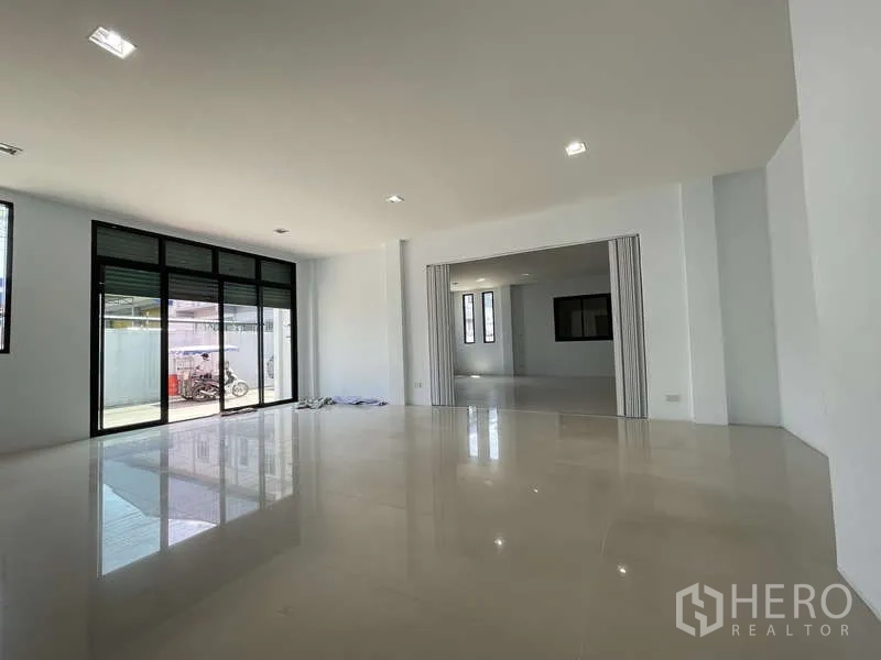 โรงงาน ให้เช่าในBan Phaeo, Samut Sakhon - ออฟฟิศชั้นล่างโปร่งโล่ง หน้าต่างบานใหญ่ ประตูกระจกสไลด์เชื่อมพื้นที่โหลดสินค้า.