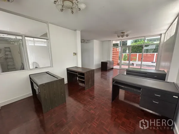 带办公室的家 出租在Watthana, Bangkok - 前厅式接待区，整面玻璃立面与抛光木地板、办公桌。