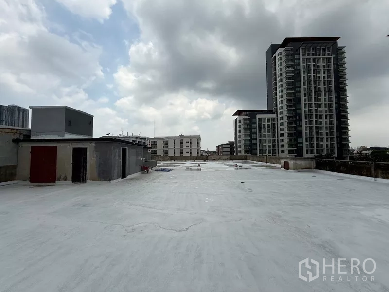 Shophouse for rent - Rooftop terrace with district skyline and surrounding condominium towers.