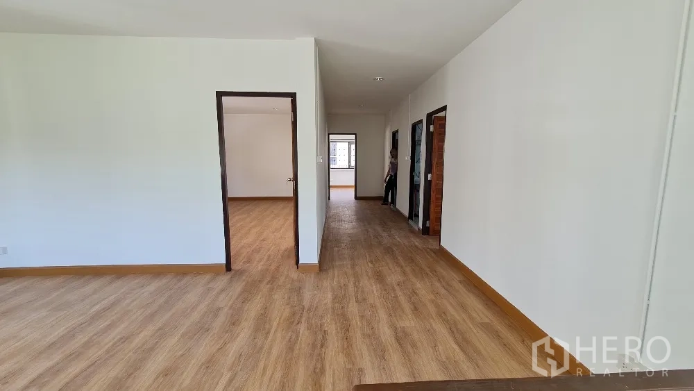 Detached House for rent in Lat Phrao, Bangkok - Large upstairs landing and corridor with wood floors leading to multiple rooms.