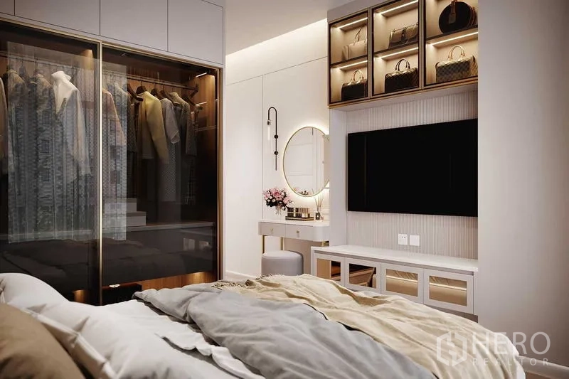 Condominium for rent in Bang Rak, Bangkok - Master bedroom corner with illuminated wardrobe, vanity table with round mirror, and wall-mounted TV.