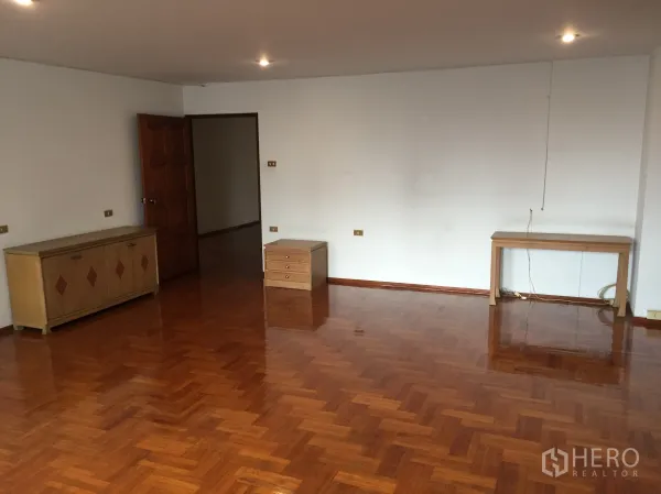 公寓 出租在Watthana, Bangkok - 宽大的起居空间，抛光木地板与简约家具