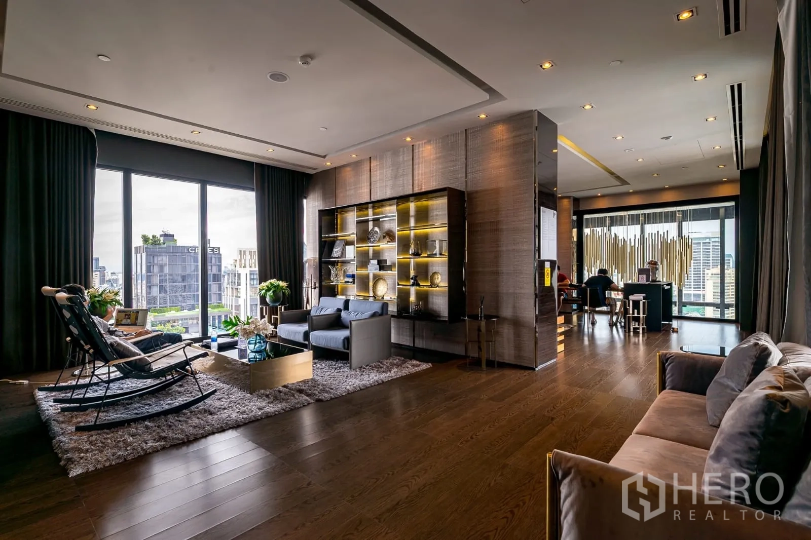 Condominium for rent in Watthana, Bangkok - Residents’ lounge with floor-to-ceiling windows and city outlook.