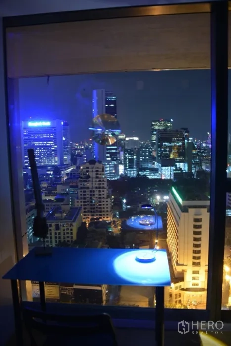 Condominium for rent or sale in Sathon, Bangkok - Desk by the window overlooking Bangkok city lights at night.