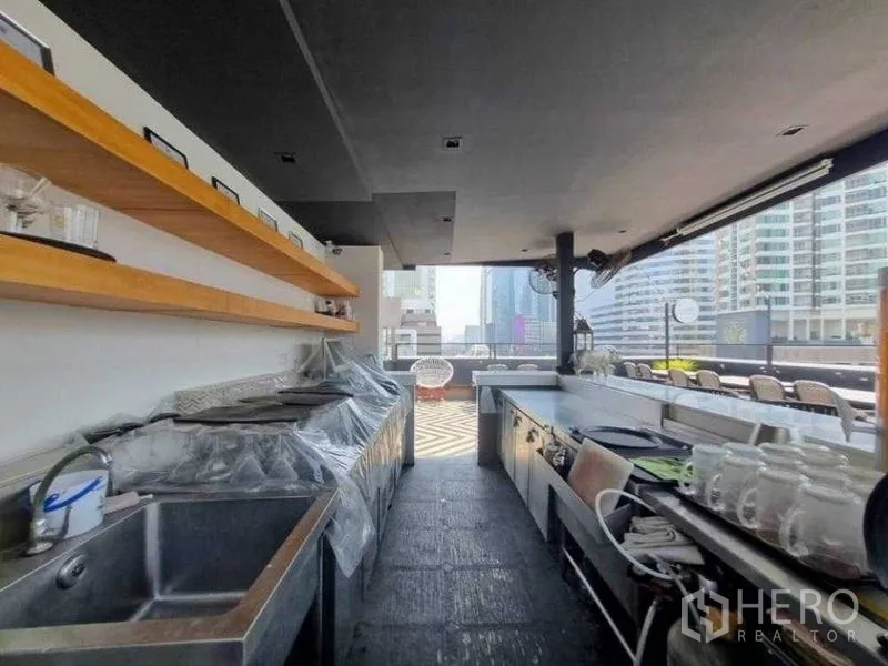 Retail Space for rent in Bang Rak, Bangkok - Covered outdoor bar with long counters and wooden shelves.