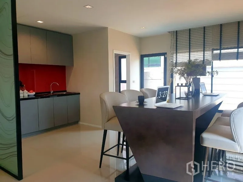 Home Office for rent - Second pantry with grey cabinetry, red backsplash and high counter seating.