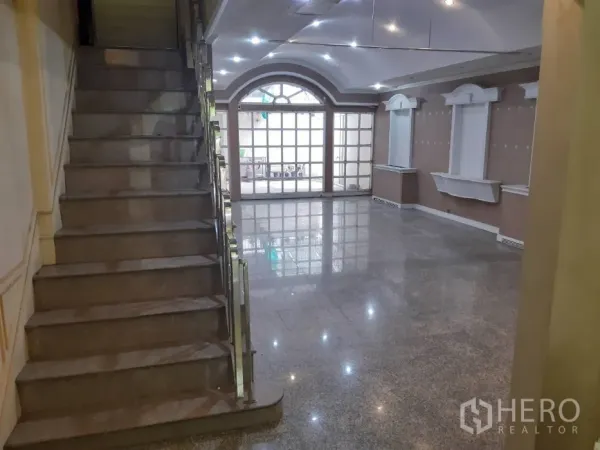 联排别墅 出租在Khlong Toei, Bangkok - 开放式起居区，带楼梯、嵌入式照明与大面积玻璃门。