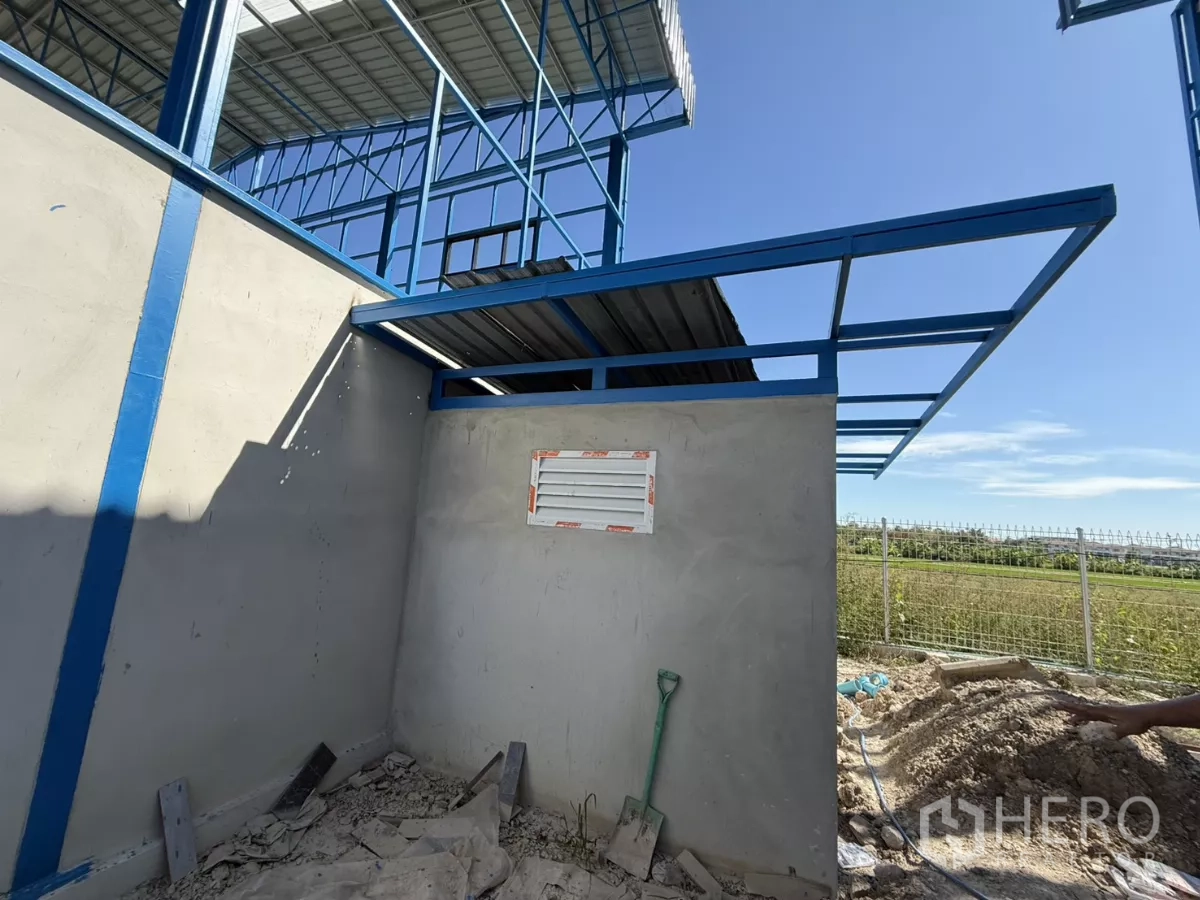 Warehouse for rent in Lam Luk Ka, Pathum Thani - External restroom block under a steel canopy frame beside the warehouse.