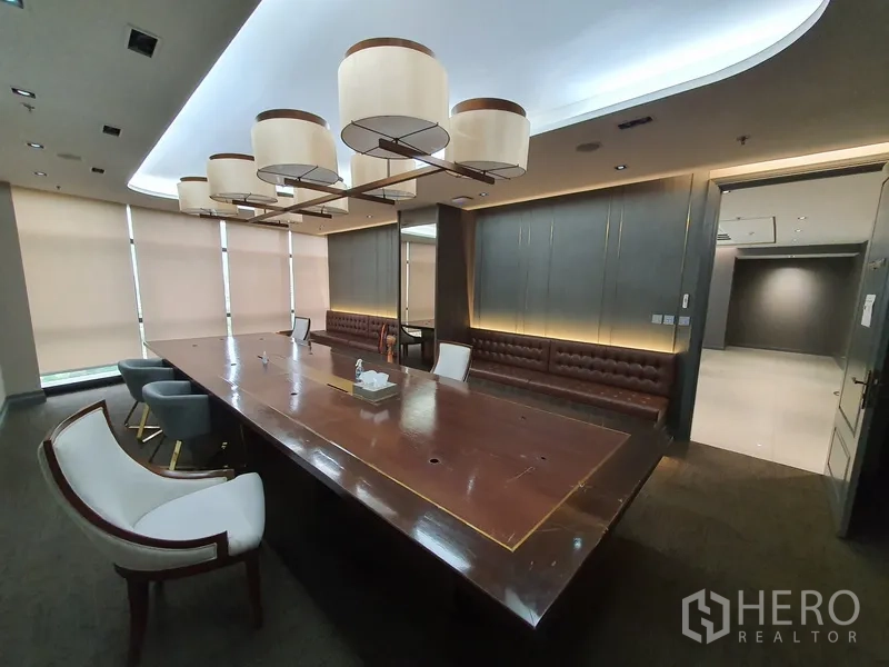 Office Space for rent in Khlong Toei, Bangkok - Boardroom angle showing built-in bench seating and soft lighting.