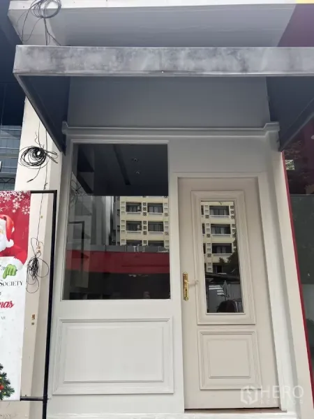 Retail Space for rent in Watthana, Bangkok - White storefront facade with large display window, paneled door and awning on a Thonglor retail strip.