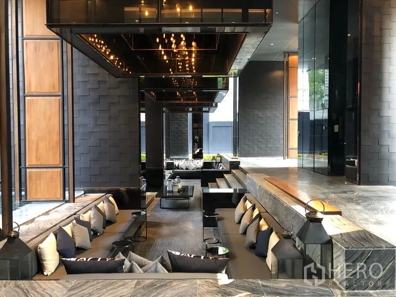 公寓 出租在Watthana, Bangkok - 酒店式大堂休息区，阶梯式座位与暖色灯光