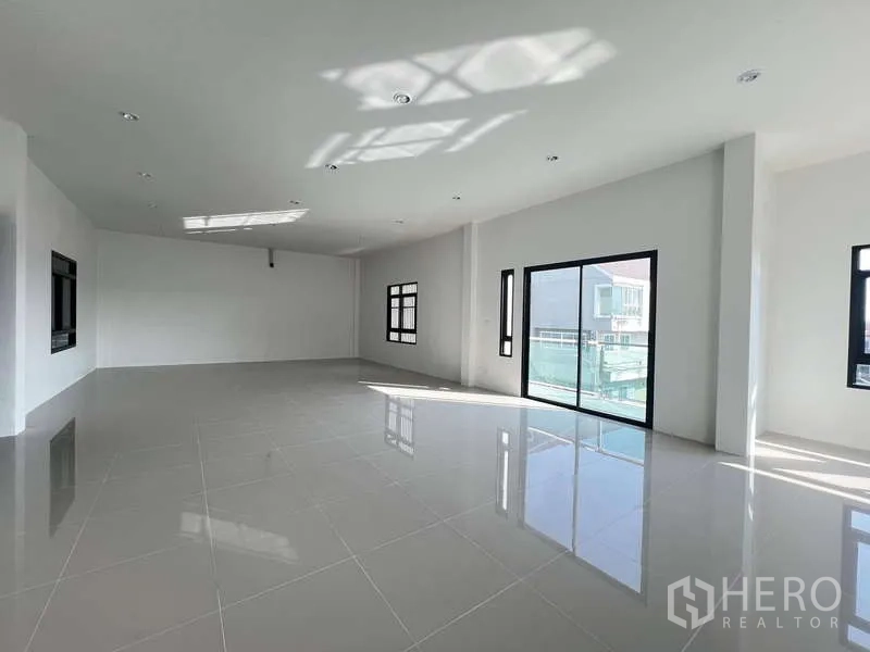 Warehouse for rent or sale - Open office floor with balcony access and wide windows bringing daylight.