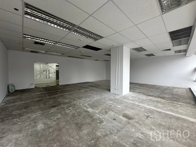 Office Space for rent in Watthana, Bangkok - Spacious white-walled office floor with grid ceiling lights and glass entrance.