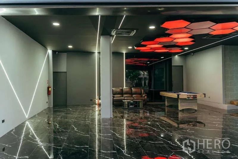 Detached House for sale in Sai Mai, Bangkok - Spacious multi‑purpose room with marble flooring, LED strip lighting and a game table.