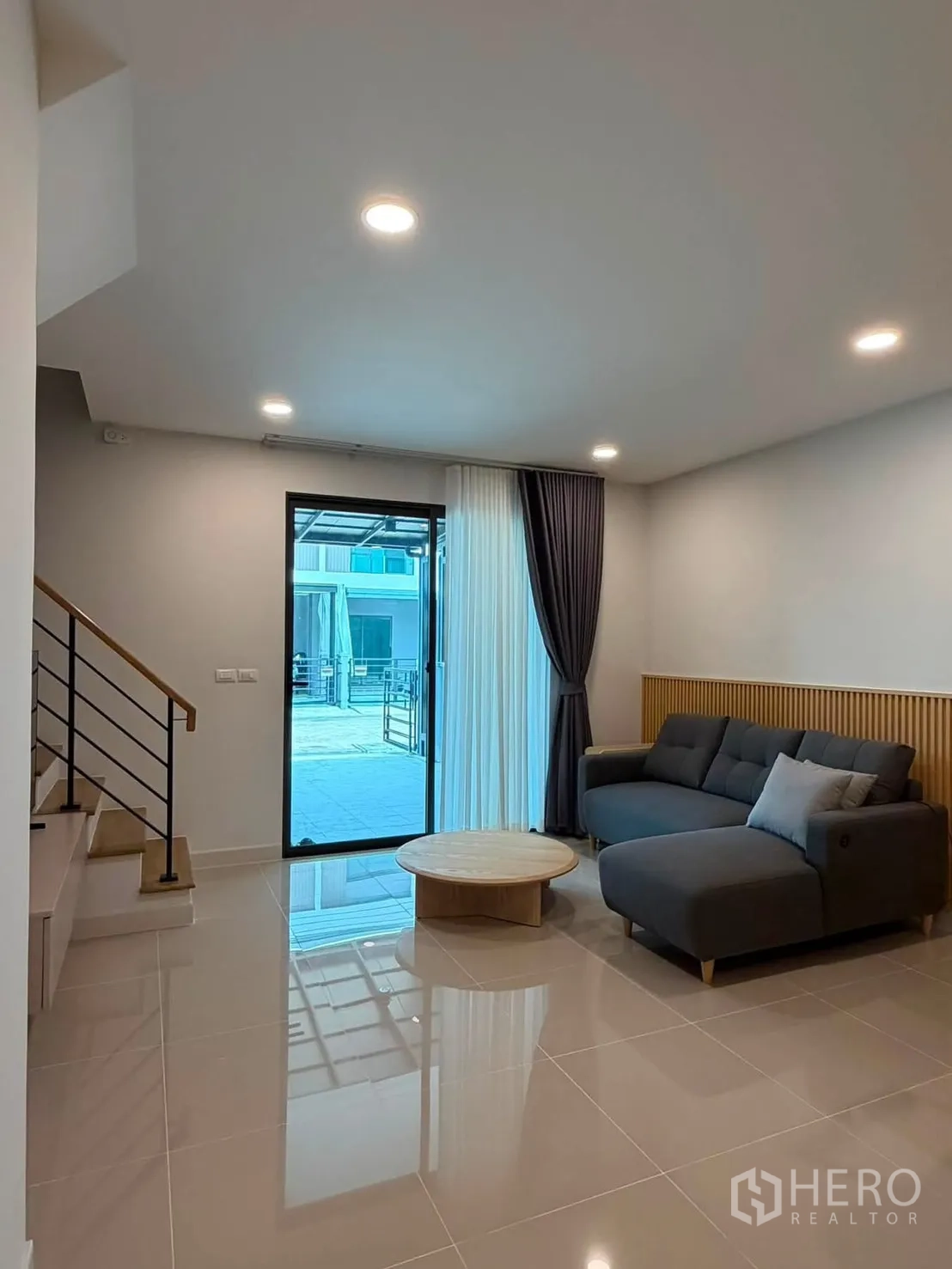 ทาวน์เฮาส์ for rent in Bang Phli, Samut Prakan - ห้องนั่งเล่นโอเพ่นแปลน โซฟาเข้ามุม โต๊ะกลาง บันได และประตูบานเลื่อน