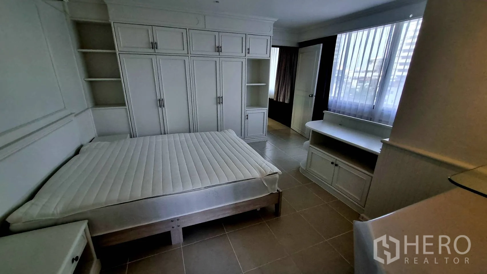 Condominium for rent in Watthana, Bangkok - Bathroom with window, toilet, long counter and shower point.