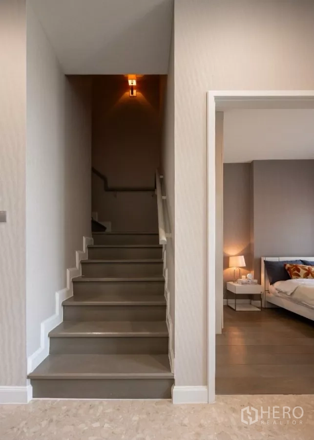 Condominium for rent or sale in Khlong Toei, Bangkok - Staircase corridor to the upper floor beside a bedroom entrance.
