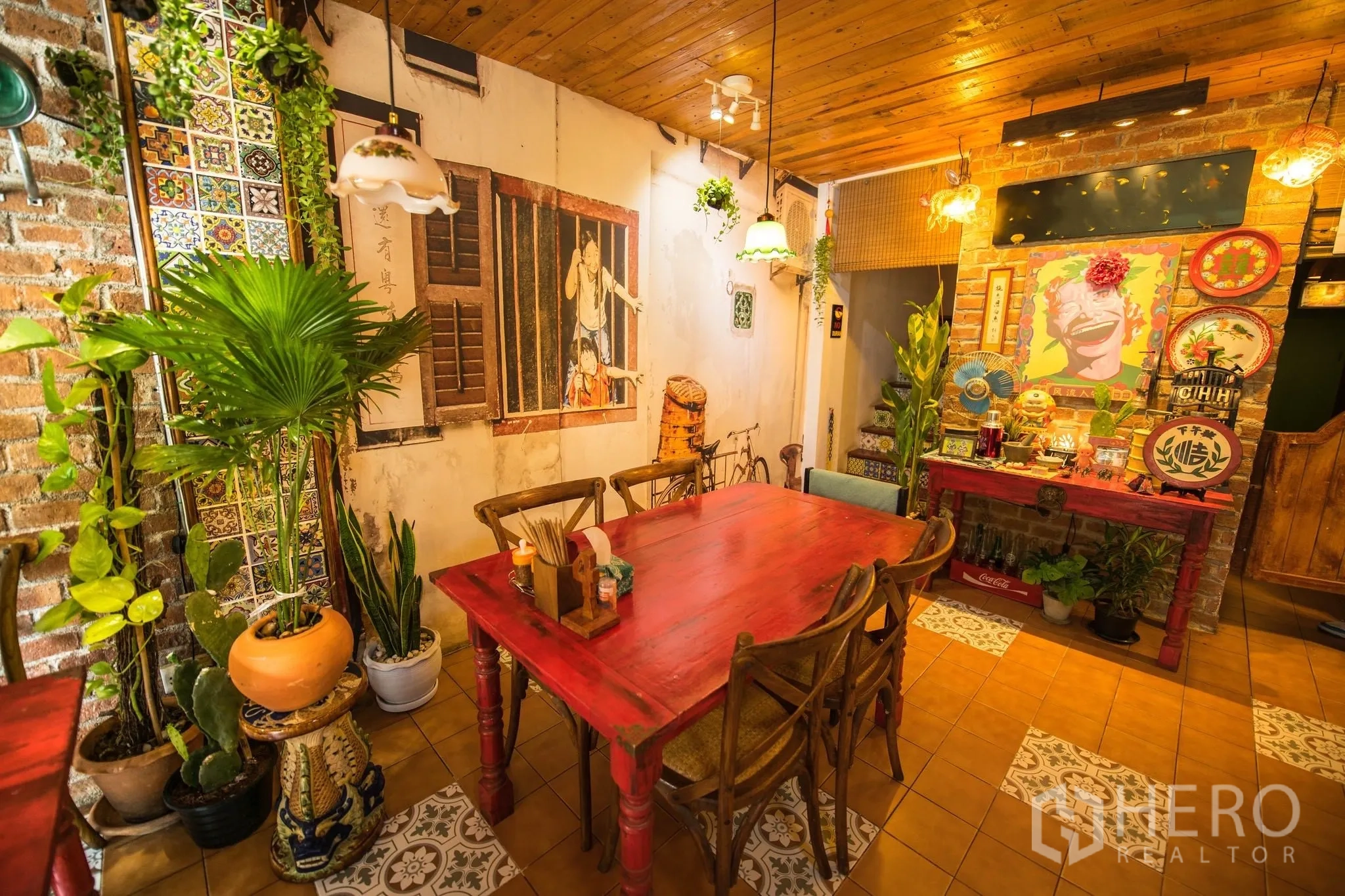 Retail Space for rent in Watthana, Bangkok - Table setting beside potted plants, patterned tiles, and a mural wall in a rustic cafe interior.
