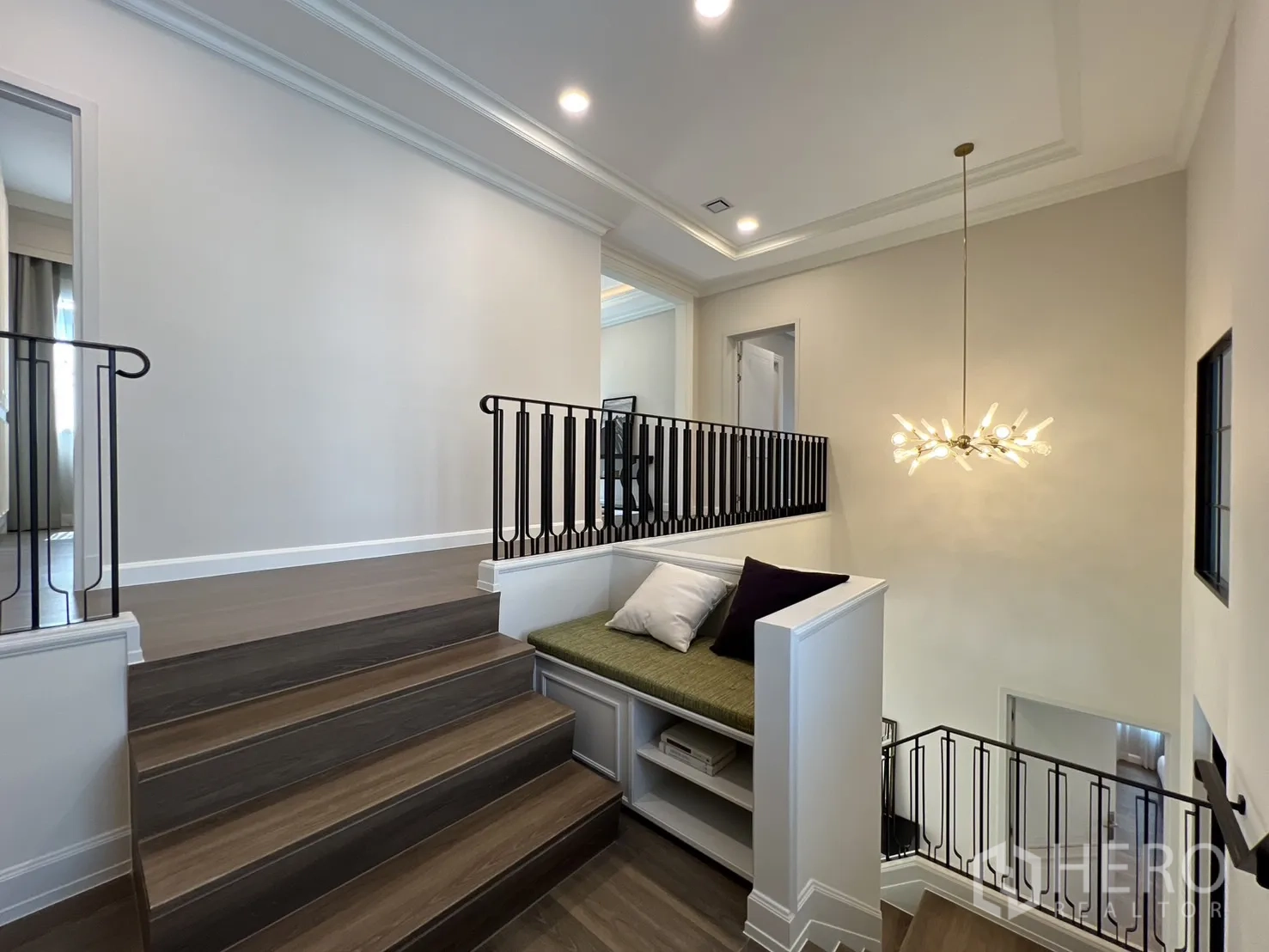 Detached House for rent in Saphan Sung, Bangkok - Landing with built‑in bench and modern chandelier above stairs.