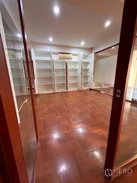 Home Office for rent or sale in Bang Phli, Samut Prakan - Private office or library room with parquet flooring, shelving units and air-conditioner.