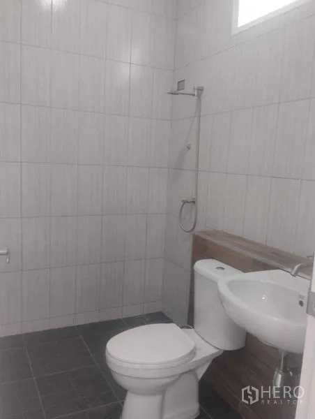 Detached House for sale in Phra Khanong, Bangkok - Shower bathroom with gray tiles, toilet and wall-mounted basin.