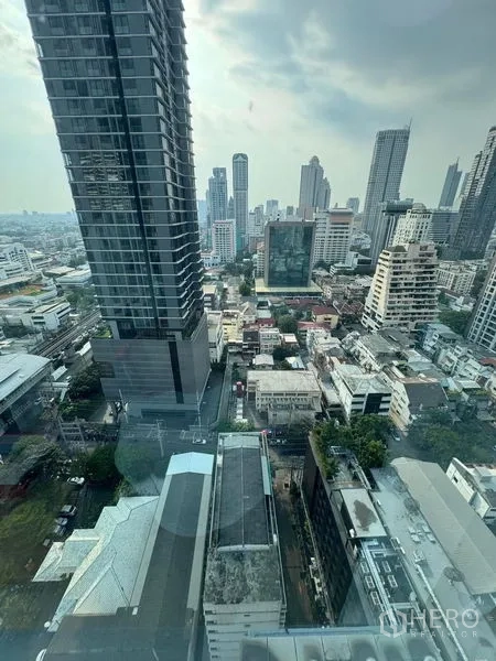 Condominium for rent or sale - High-floor city view overlooking mixed residential and office buildings in the Sathorn area.