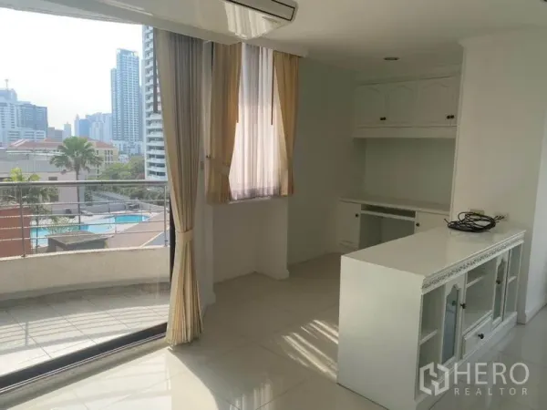 Condominium for rent in Watthana, Bangkok - Dining and cabinet corner opening to a balcony with city and swimming pool views.