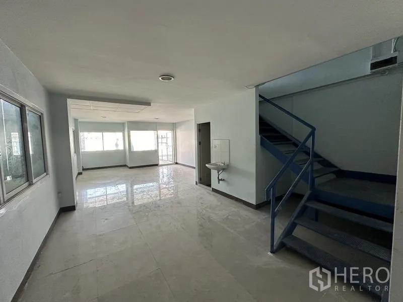 Warehouse for rent in Bueng Kum, Bangkok - Office foyer featuring metal staircase, sliding windows and bright natural light.