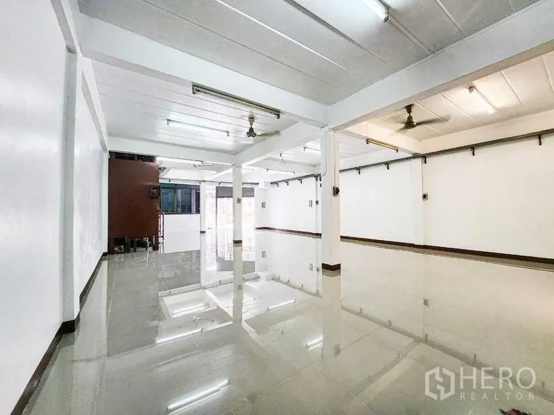 Home Office for rent in Khlong Toei, Bangkok - Long open workspace with exposed beams, ceiling fans and a bright entrance.