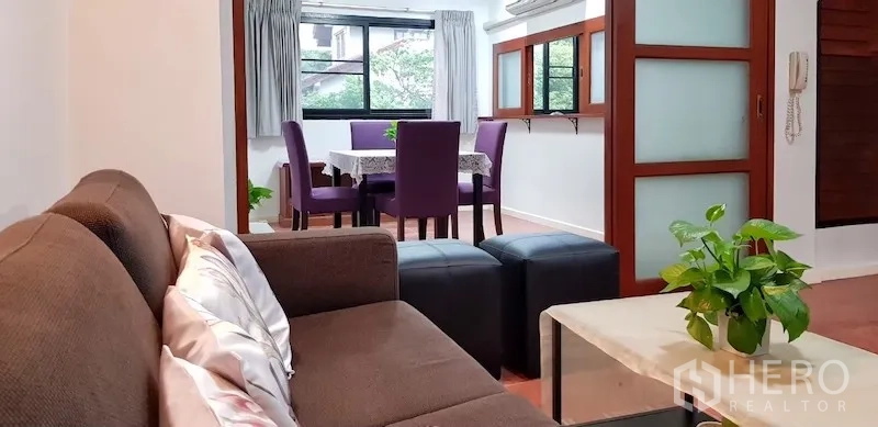 Detached House for rent in Chatuchak, Bangkok - Cozy sitting room opening to dining space with sliding panels and greenery views.