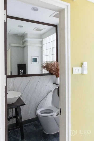 Townhouse for sale - Compact guest restroom with vessel sink and toilet.
