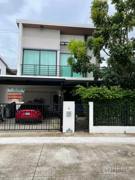 Detached House for sale in Samut Prakan - Modern two-storey detached house facade with carport and front gate.