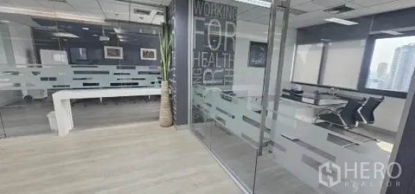 Office Space for rent in Bang Rak, Bangkok - Silom office space interior with glass-walled meeting room, frosted partitions, light wood floors and city views.