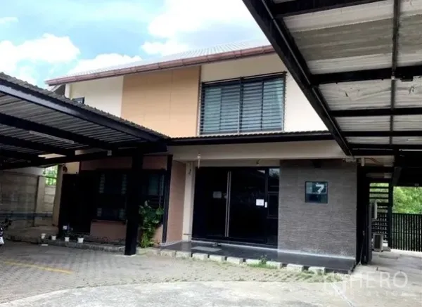 Home Office for rent in Lat Phrao, Bangkok - Two-storey home office facade with large windows and a covered driveway and entry.