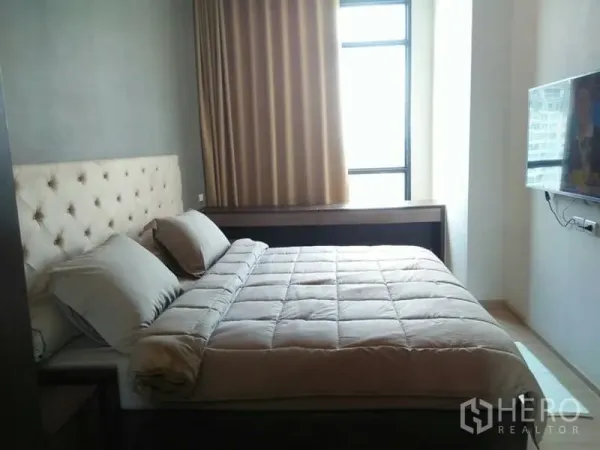 公寓 出租在Huai Khwang, Bangkok - 采光充足的主卧，落地窗、墙挂电视与软包床头。