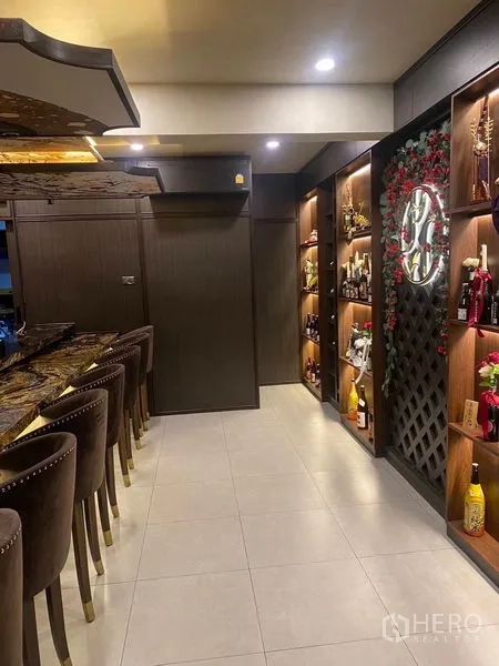 Shophouse for rent - Hallway featuring illuminated wooden display shelves with bottles and decor.