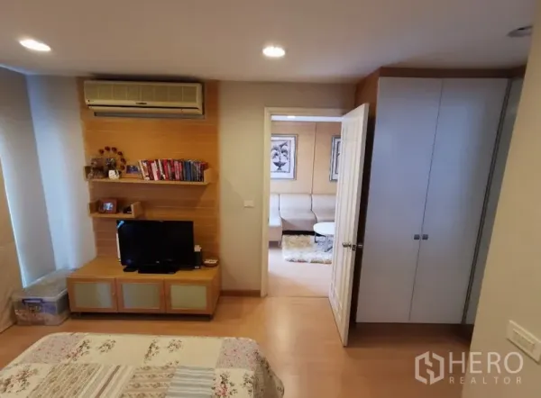 Condominium for sale in Sathon, Bangkok - Master bedroom with built-in wardrobe, shelves, TV console and air conditioning.