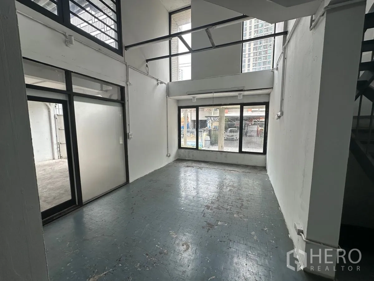 Home Office for rent in Chatuchak, Bangkok - Double-height lobby or workspace with full-height windows and glass doors.